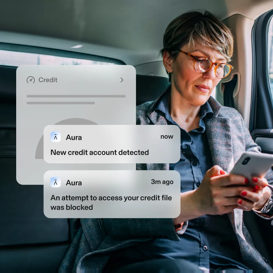 Woman reading Aura alerts in a car.
